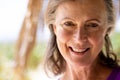 Close-up portrait of happy caucasian beautiful senior woman with brown eyes looking at camera Royalty Free Stock Photo