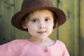 Close up portrait of happy cute little girl in rural style brown hat in a summer day Royalty Free Stock Photo