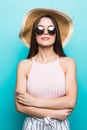 Close up portrait of happy young woman in beach hat and sunglasses over blue background Royalty Free Stock Photo