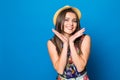 Portrait of a happy excited young woman in beach hat with smile looking at camera isolated over blue background Royalty Free Stock Photo