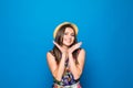 Portrait of a happy excited young woman in beach hat with smile looking at camera isolated over blue background Royalty Free Stock Photo