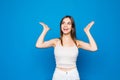 Close up portrait of a happy excited young woman with mouth open isolated over blue background Royalty Free Stock Photo