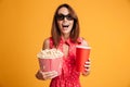 Close-up portrait of happy exited woman in 3d glasses holding co