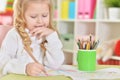 Close up portrait of happy girl drawing with colorful pencils Royalty Free Stock Photo