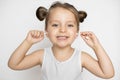 Close up portrait of happy laughing three years old kid girl, posing to camera with teeth smile and cleaning her little