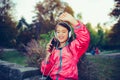 Close up portrait happy little girl dancing, singing and listening music with headphones and smart phone outdoor Royalty Free Stock Photo