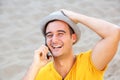 Close up happy man with hat talking on mobile phone at the beach Royalty Free Stock Photo