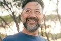 Close up portrait of happy man smiling outside in the park enjoying outdoor leisure activity alone. Bearded male people adult Royalty Free Stock Photo