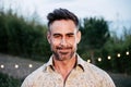 Close Up Portrait of happy mature adult Man Looking and smiling at Camera standing outdoors Royalty Free Stock Photo