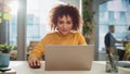 Close Up Portrait of a Happy Middle Eastern Manager Sitting at a Desk in Creative Office. Young Royalty Free Stock Photo