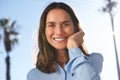 Close up happy older woman laughing Wirth hand in hair outside