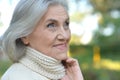 Close up portrait of happy older woman standing outside Royalty Free Stock Photo