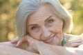 Close up portrait of happy older woman standing outside in summer Royalty Free Stock Photo