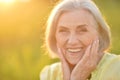 Close up portrait of happy older woman standing outside in summer Royalty Free Stock Photo