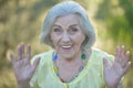 Close up portrait of happy older woman standing outside in summer Royalty Free Stock Photo