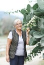 Close up portrait of happy older woman standing outside in summer Royalty Free Stock Photo