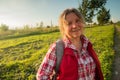 Close up portrait of happy older woman standing outside in summer on field background. Royalty Free Stock Photo