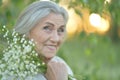 Close up portrait of happy older woman standing outside in summer Royalty Free Stock Photo