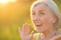 Close up portrait of happy older woman standing outside in summer Royalty Free Stock Photo