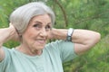 Close up portrait of happy older woman standing outside in summer Royalty Free Stock Photo