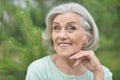 Close up portrait of happy older woman standing outside in summer Royalty Free Stock Photo