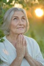 Close up portrait of happy older woman standing outside in summer Royalty Free Stock Photo