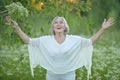 Close up portrait of happy older woman standing outside in summer Royalty Free Stock Photo