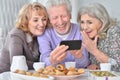 Close up portrait of senior people with smartphone drinking tea Royalty Free Stock Photo