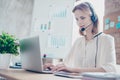 Close up portrait of happy smiling confident experienced qualified young professional operator of call center, she is sitting