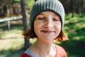 Close up portrait of a happy smiling freckled girl in a forest with eyes closed Royalty Free Stock Photo