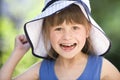 Close-up portrait of happy smiling little girl in a big hat. Child having fun time outdoors in summer Royalty Free Stock Photo