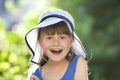 Close-up portrait of happy smiling little girl in a big hat. Child having fun time outdoors in summer Royalty Free Stock Photo