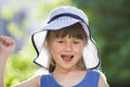 Close-up portrait of happy smiling little girl in a big hat. Child having fun time outdoors in summer Royalty Free Stock Photo
