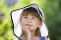 Close-up portrait of happy smiling little girl in a big hat. Child having fun time outdoors in summer Royalty Free Stock Photo