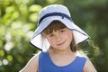 Close-up portrait of happy smiling little girl in a big hat. Child having fun time outdoors in summer Royalty Free Stock Photo