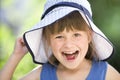 Close-up portrait of happy smiling little girl in a big hat. Child having fun time outdoors in summer Royalty Free Stock Photo