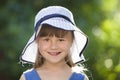 Close-up portrait of happy smiling little girl in a big hat. Child having fun time outdoors in summer Royalty Free Stock Photo