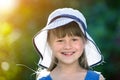 Close-up portrait of happy smiling little girl in a big hat. Child having fun time outdoors in summer Royalty Free Stock Photo