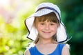 Close-up portrait of happy smiling little girl in a big hat. Child having fun time outdoors in summer Royalty Free Stock Photo