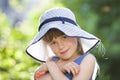 Close-up portrait of happy smiling little girl in a big hat. Child having fun time outdoors in summer Royalty Free Stock Photo