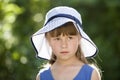 Close-up portrait of happy smiling little girl in a big hat. Child having fun time outdoors in summer Royalty Free Stock Photo