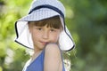 Close-up portrait of happy smiling little girl in a big hat. Child having fun time outdoors in summer Royalty Free Stock Photo