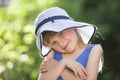 Close-up portrait of happy smiling little girl in a big hat. Child having fun time outdoors in summer Royalty Free Stock Photo