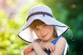 Close-up portrait of happy smiling little girl in a big hat. Child having fun time outdoors in summer Royalty Free Stock Photo