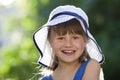 Close-up portrait of happy smiling little girl in a big hat. Child having fun time outdoors in summer Royalty Free Stock Photo