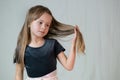 Close-up portrait of happy smiling little girl holding in hands her long hair Royalty Free Stock Photo