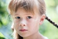 Close-up portrait of happy smiling little girl with long hair outdoors in summer Royalty Free Stock Photo