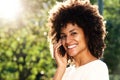 Close up happy woman talking on mobile phone in park Royalty Free Stock Photo