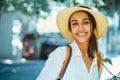 Close-up portrait happy woman tourist in straw hat, white shirt smiling and looking to camera. Vacation in Thailand. Royalty Free Stock Photo