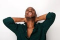 Happy young african american guy laughing with hands behind head against isolated white background Royalty Free Stock Photo